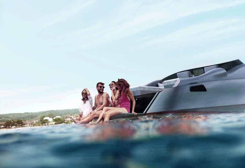 A group of people sitting on a bespoke yacht in the water.