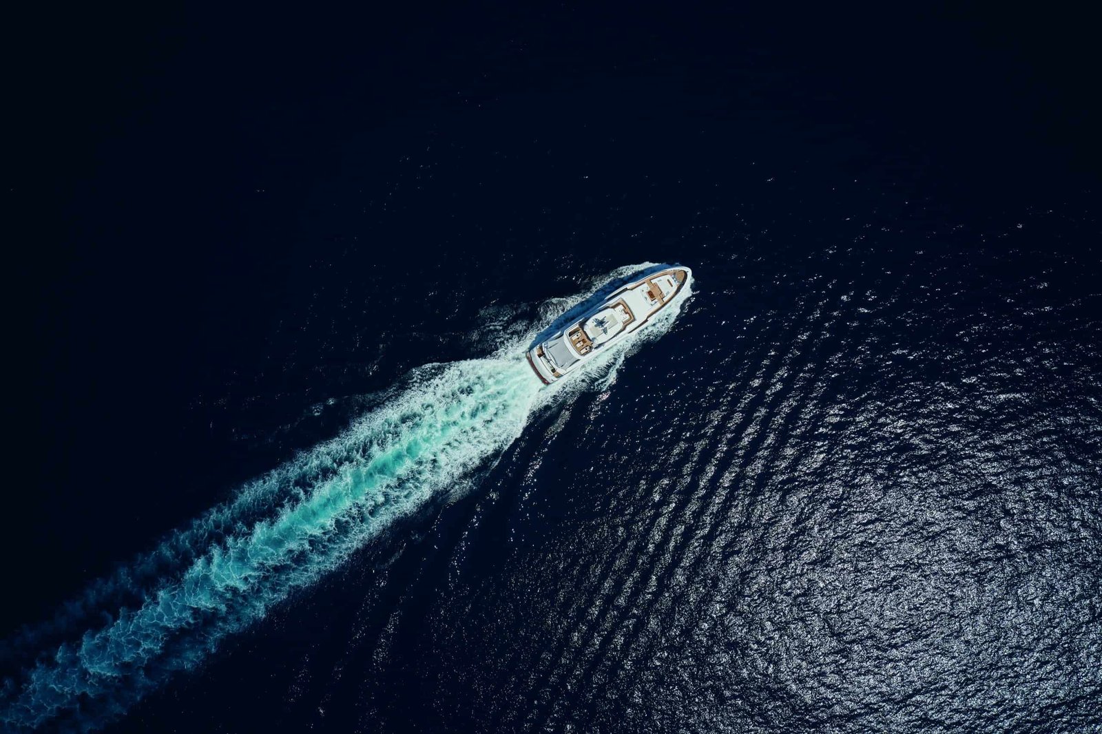 An aerial view of a luxurious boat in the ocean.