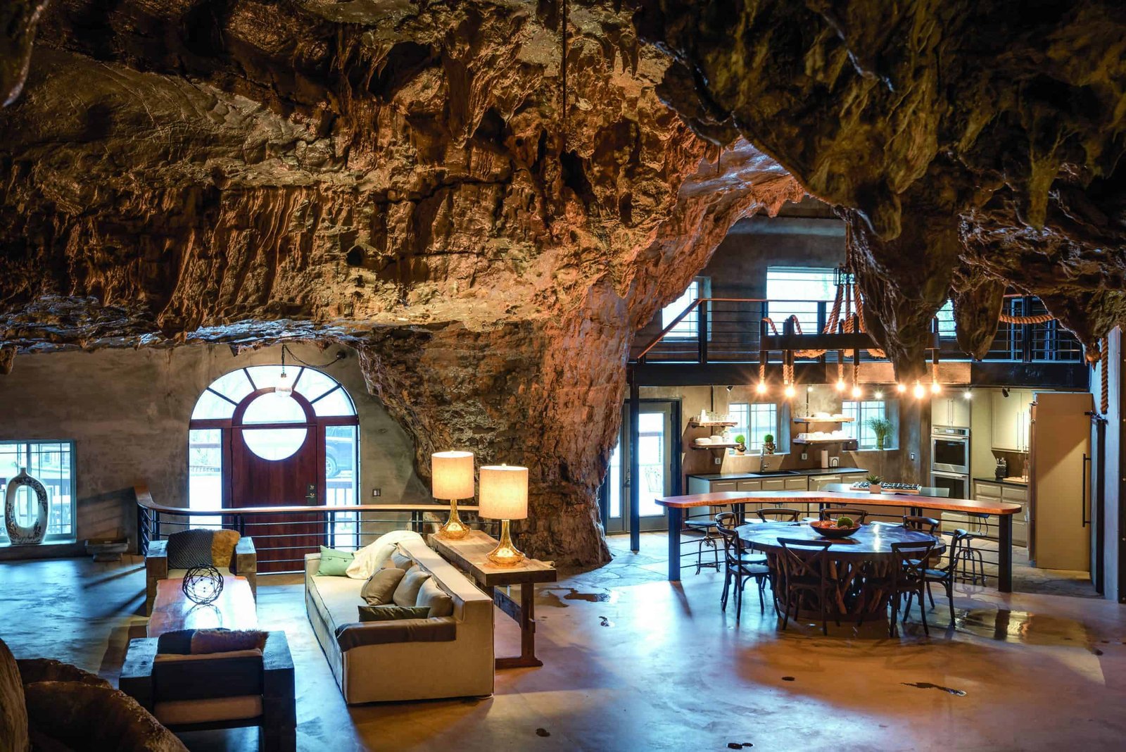 An amazing living room and dining room nestled inside a cave.
