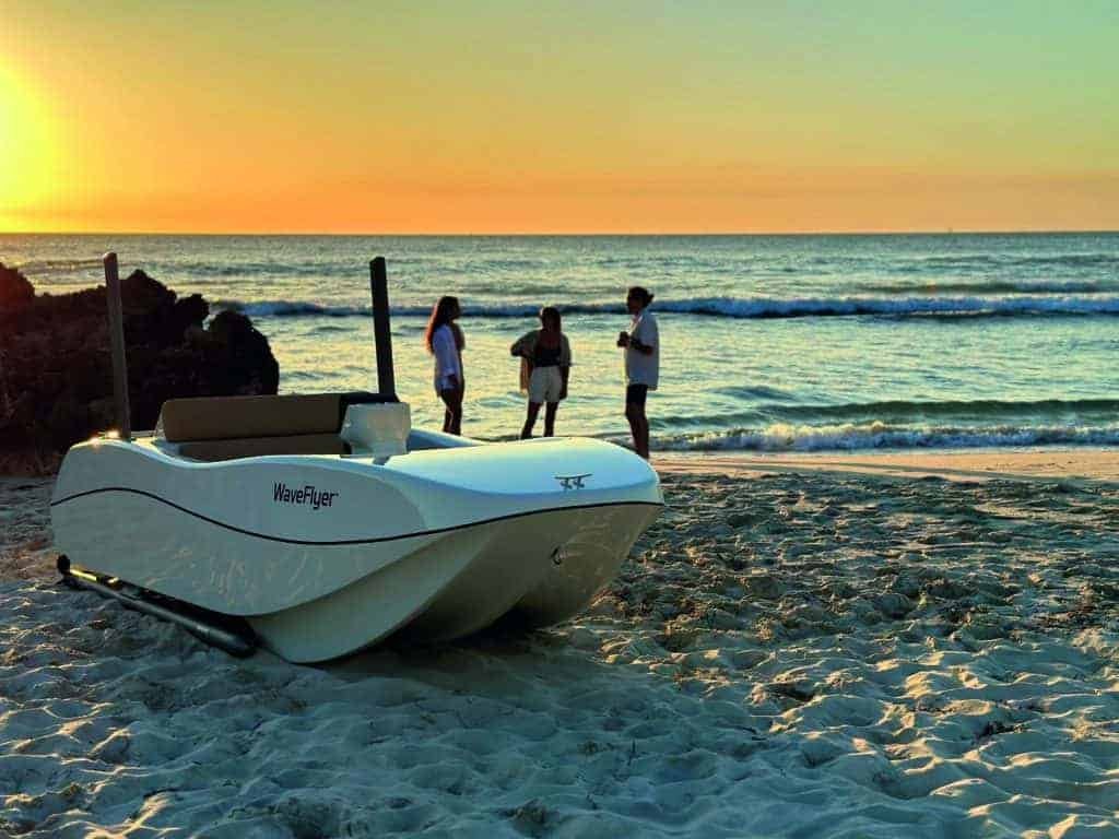 A white boat on the beach at sunset, a cut above the rest.