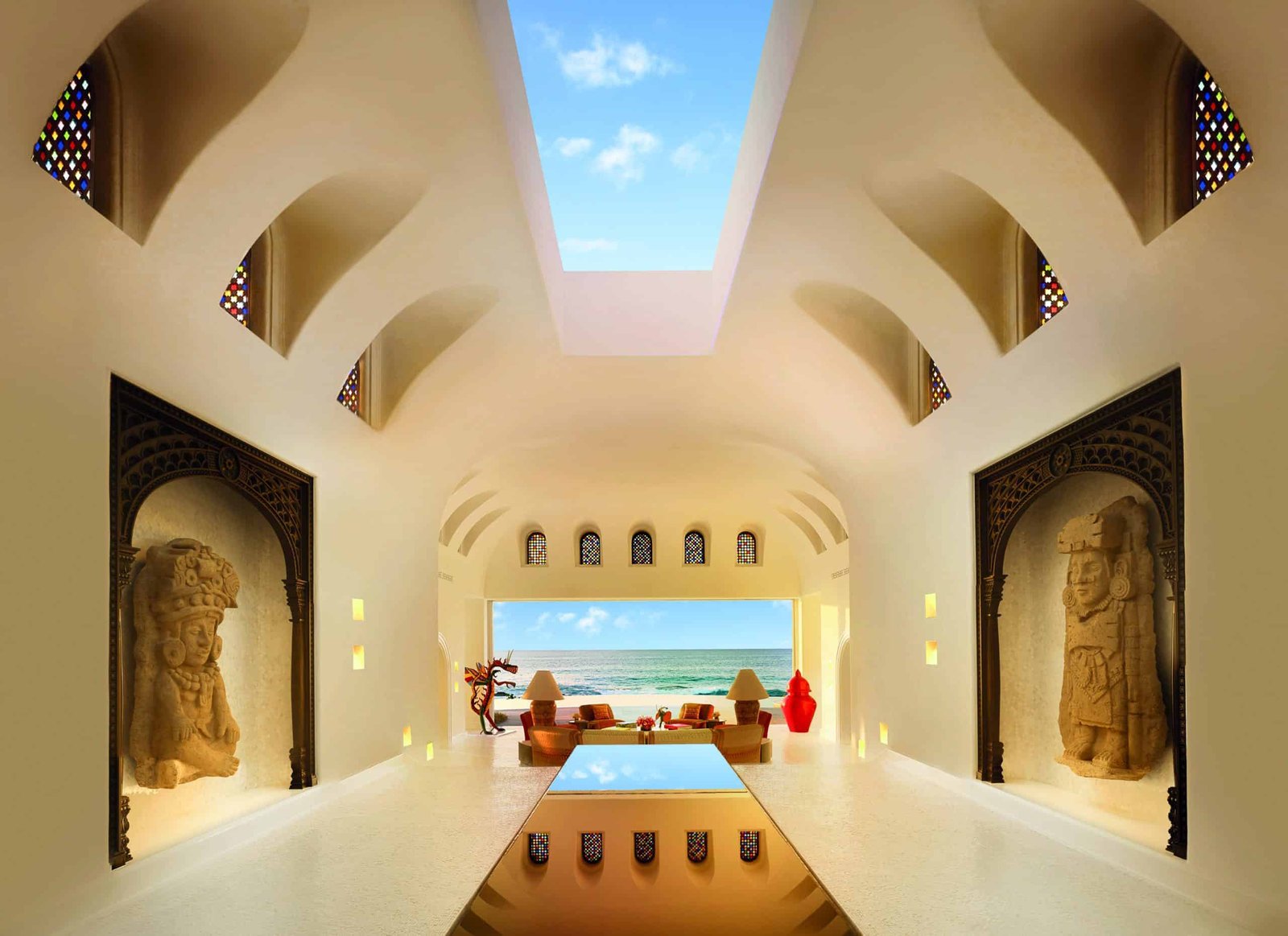 A room with arches and a panoramic view of the ocean, designed with a personal touch.
