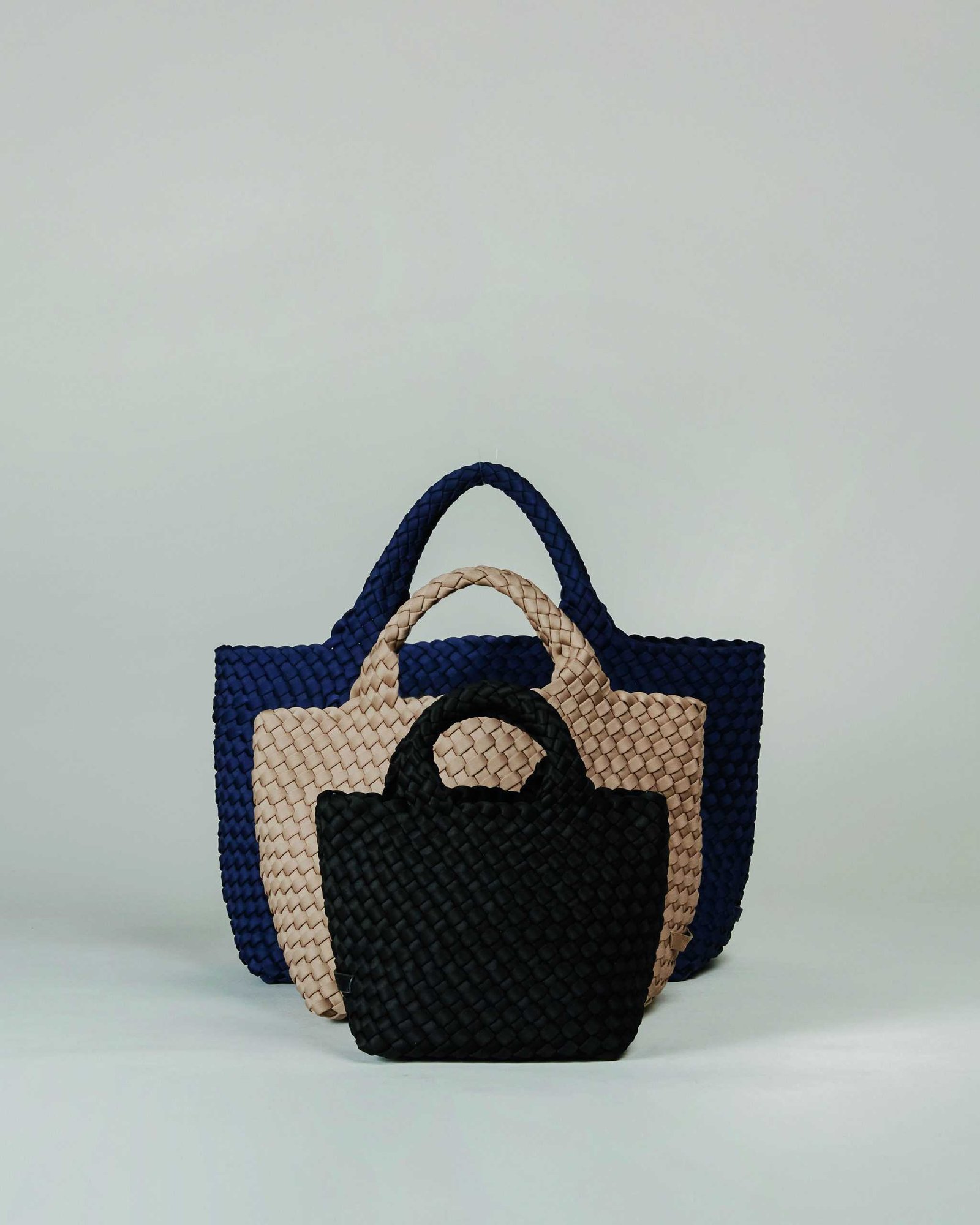 Three woven tote bags on a white background, perfect for eco-conscious individuals who want to minimize waste.