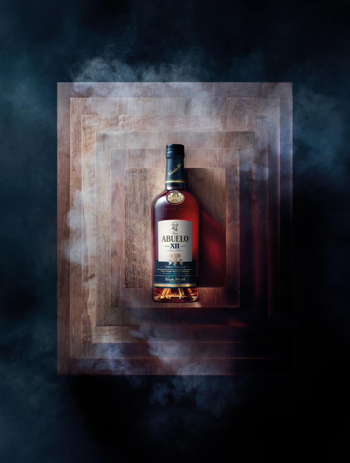 A bottle of whisky sitting on a square of smoke, surrounded by the rich aroma of rum and punches.