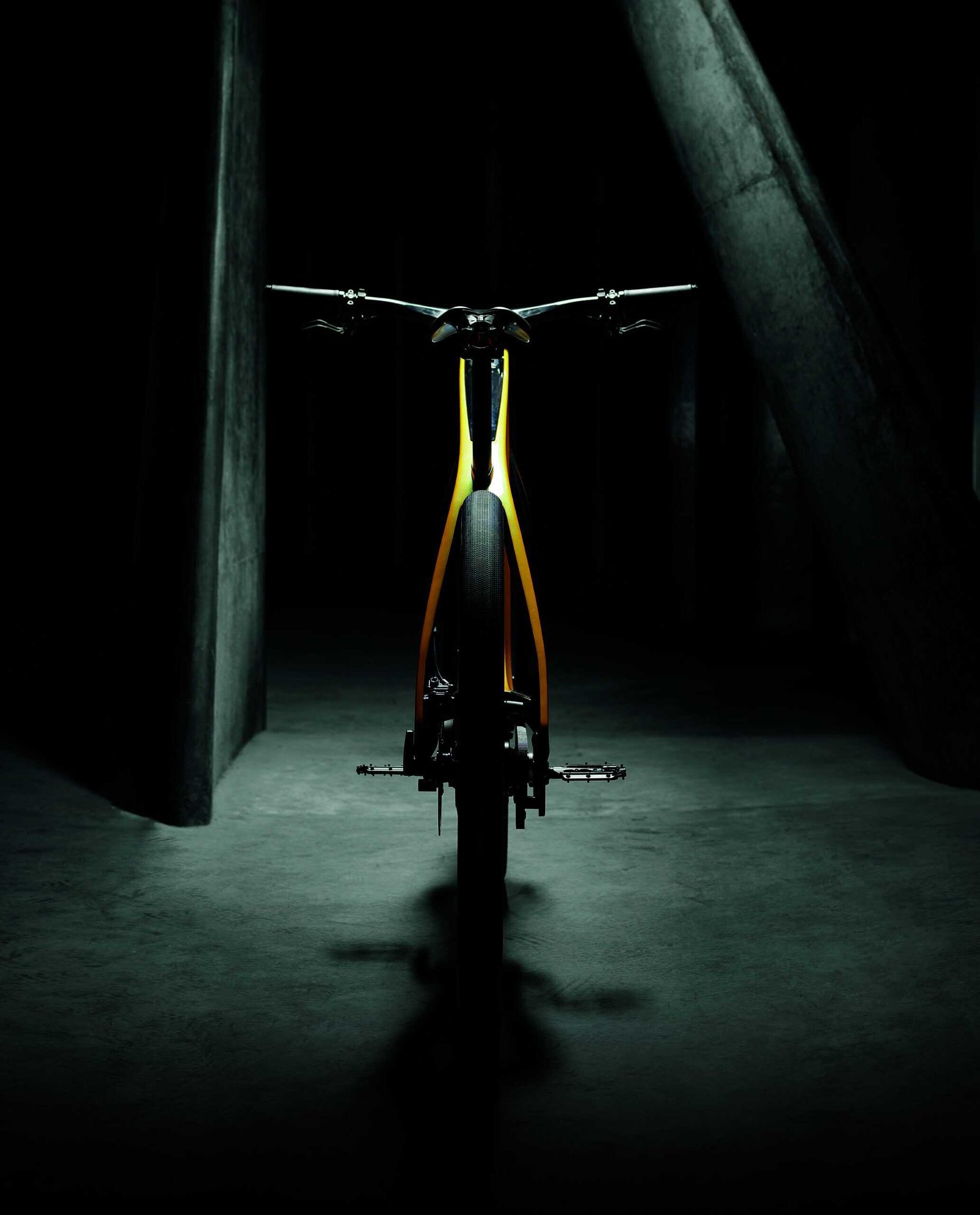 A yellow electric bike parked in a dark room, subtly hinting towards dreams.