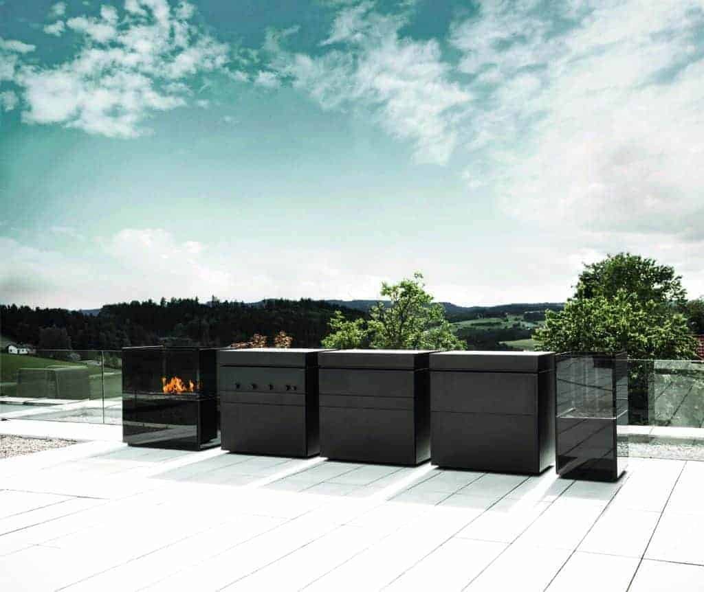 An outdoor kitchen with a black fire pit, balancing both function and form.