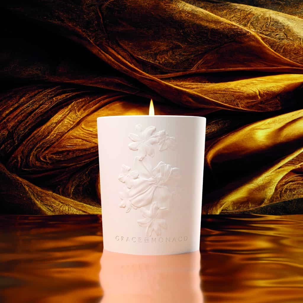 A candle is sitting on top of an IMPORTANT piece of fabric.