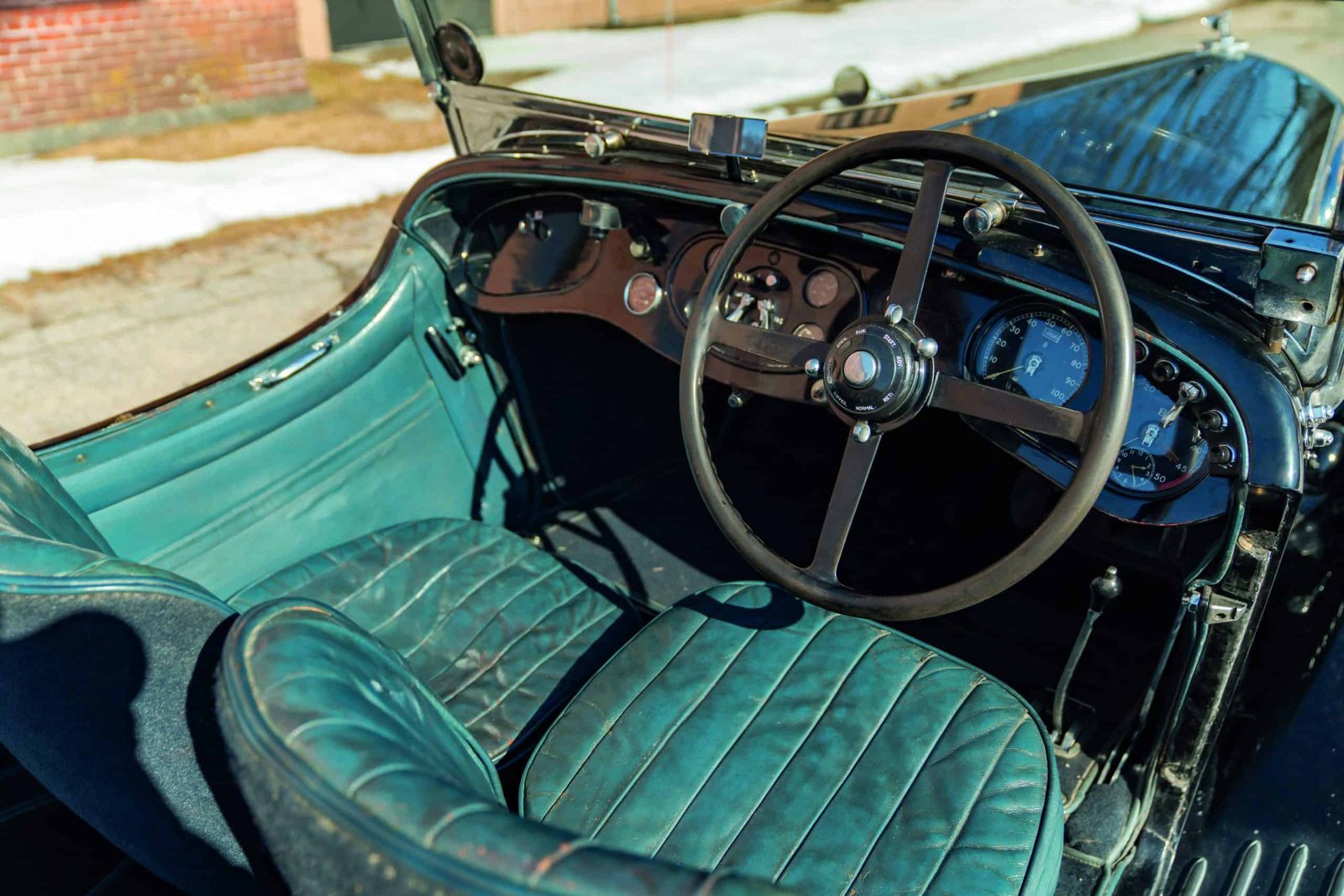 Experience the best of both worlds with the interior of a vintage car featuring plush leather seats and a classic leather-wrapped steering wheel.