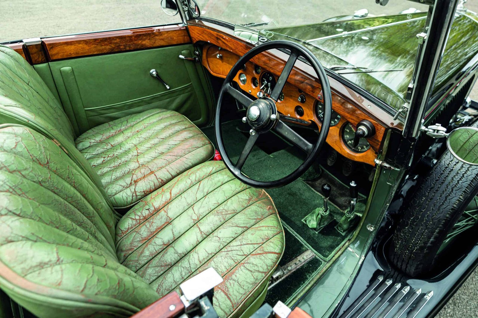 The world's best antique car with green leather seats.