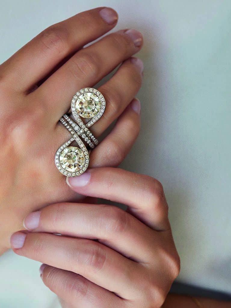 A woman's hand adorned with a dazzling diamond ring, serving as the epitome of jewel purpose.