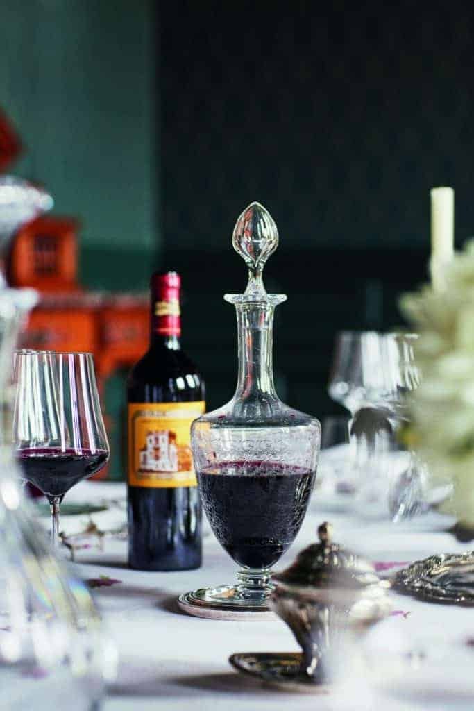 A Médoc wine decanter on a table.