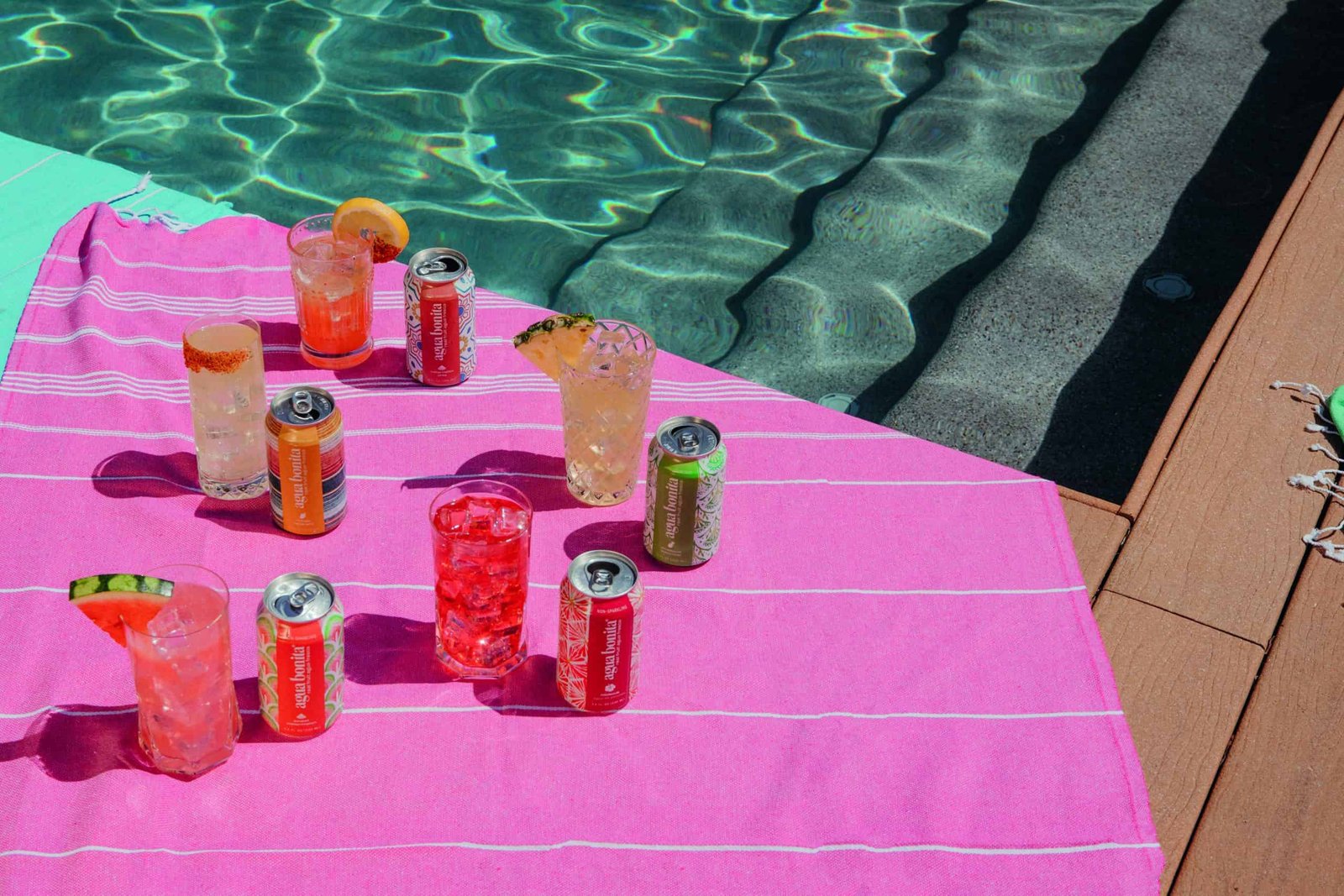 A flavourful Latin towel with drinks on it next to a pool.